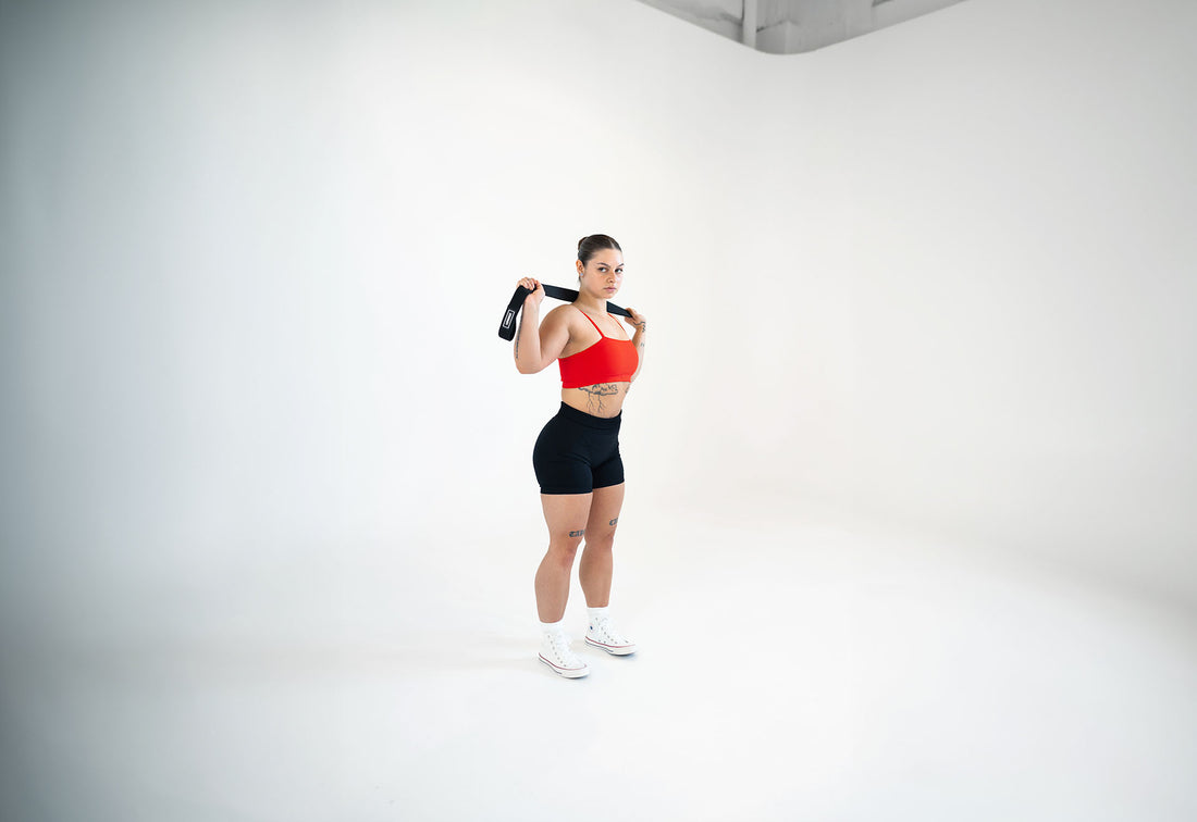 woman stretching upper body with uppper long resistance band